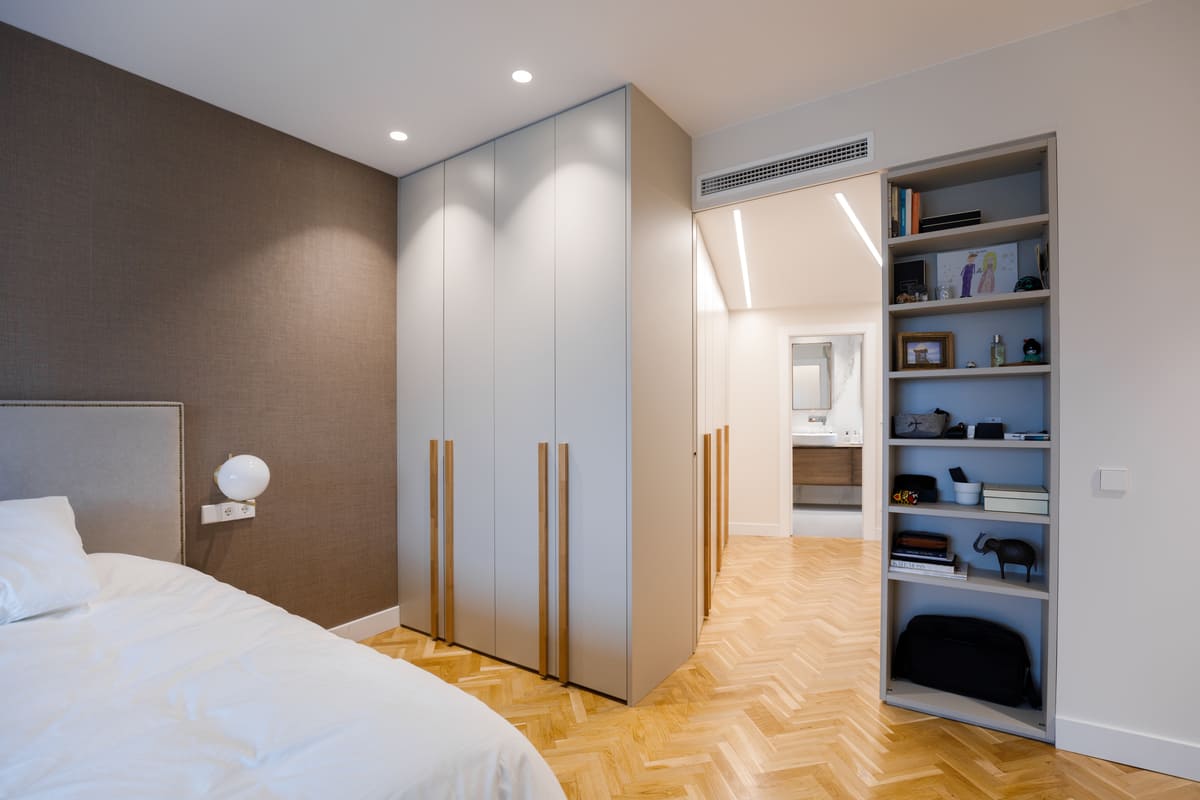 Dormitorio con armario y estantería iluminada
