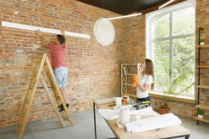 pareja joven haciendo reparacion de apartamento juntos